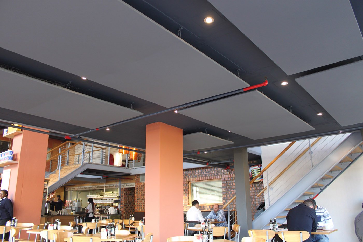 Outdoor restaurant with Alphalia Silent fabric ceiling panels for weather-resistant acoustic treatment.